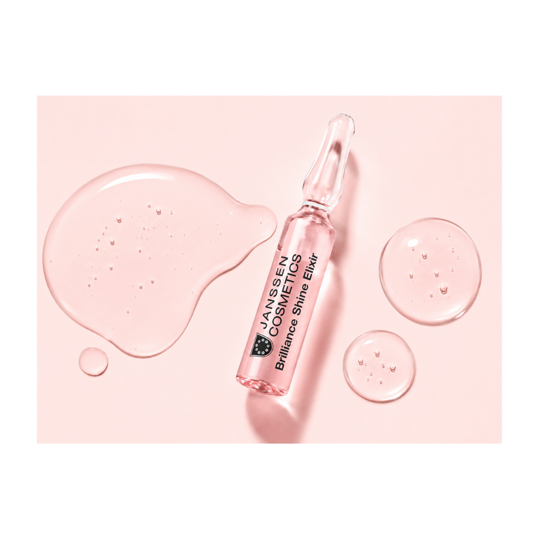 Texture of Janssen Cosmetics Brilliance Shine Elixir Ampoules on a white background.